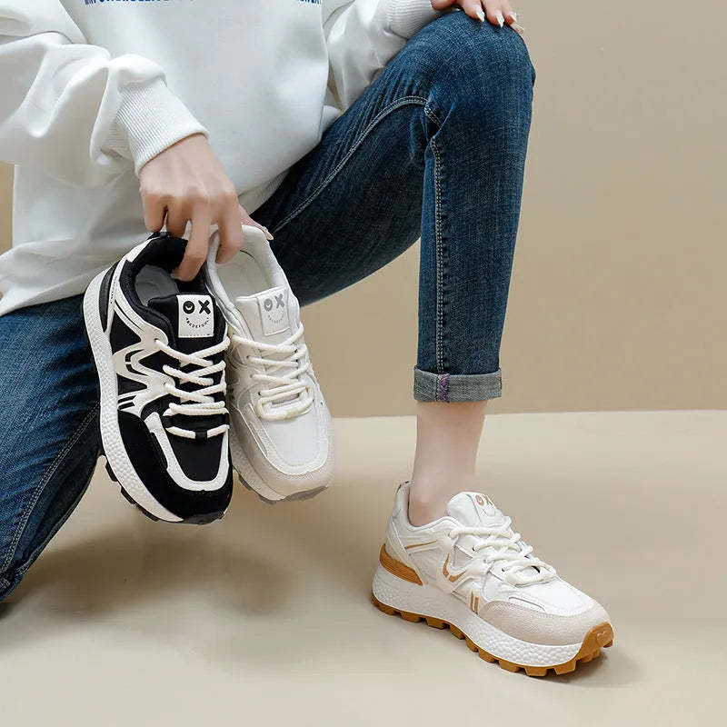 Women's black casual flat shoes with round toe and front lace-up design on a plain background.