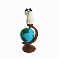 Cartoon style Statue of Liberty cat resin figurine craft on display surface.