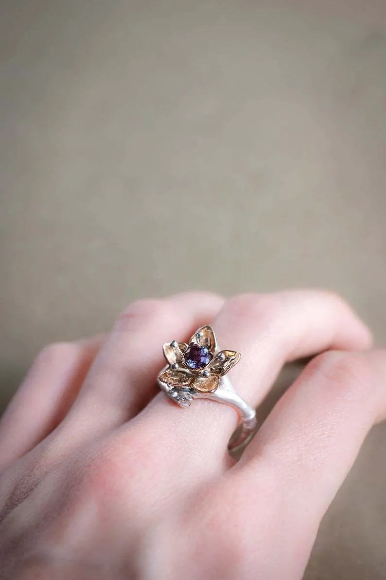 Women's two-tone floral geometric alloy ring in silver colour on display