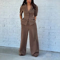 Brown polyester slim fit waist top and trousers suit set with long sleeves on mannequin