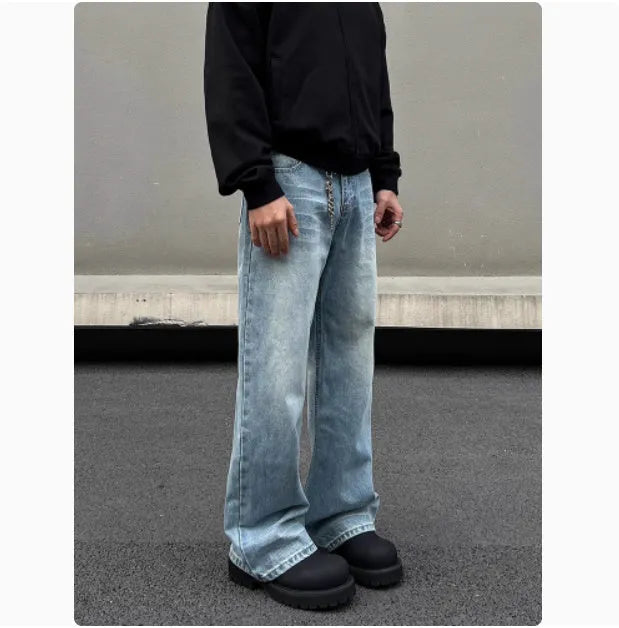 Men's blue straight-leg denim jeans with a whisker wash effect, showing a flared leg and visible stitching detail.