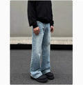 Men's blue straight-leg denim jeans with a whisker wash effect, showing a flared leg and visible stitching detail.