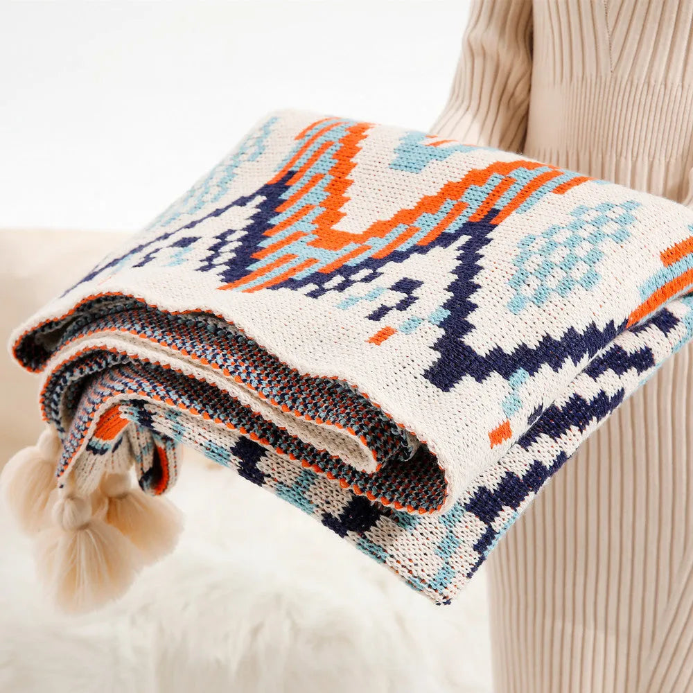 Acrylic sofa cover blanket with tassel trim in beige and orange colour.
