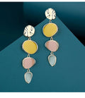 A pair of simple disc-shaped alloy earrings with a blended Morandi three-colour oil drip finish, showing a vintage wafer style.