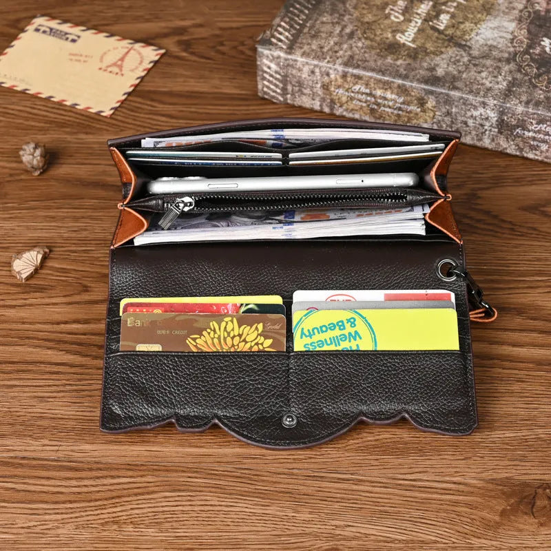 Women's brown tri-fold leather wallet with embossed floral pattern, shown open to reveal compartments.