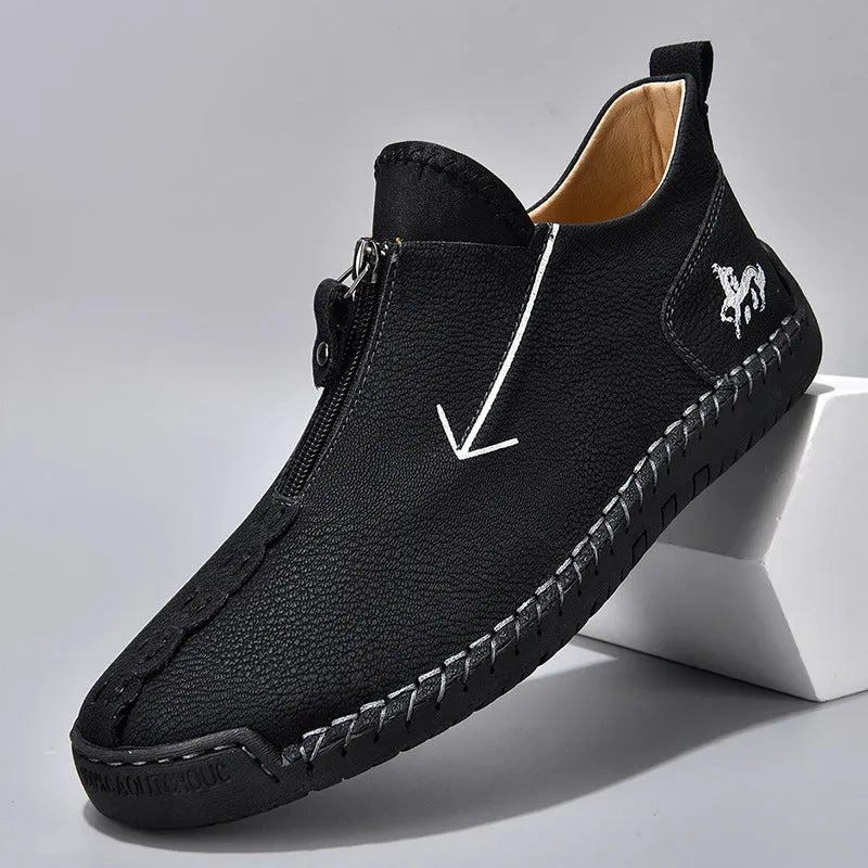 Men's black leather zip-up Martin boots with hand-stitched detail and a round toe.