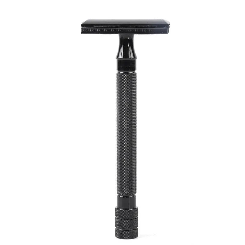 Traditional manual shaving kit showing a metal safety razor and a shaving brush on a dark background.