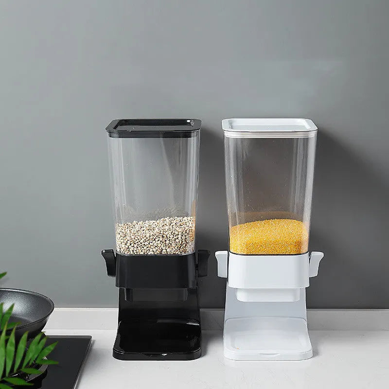 Countertop cereal dispenser in white with clear container and black lever showing chute opening
