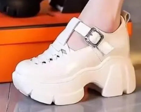 Women's black satin pumps with skull pattern and chunky wedge heel on white background