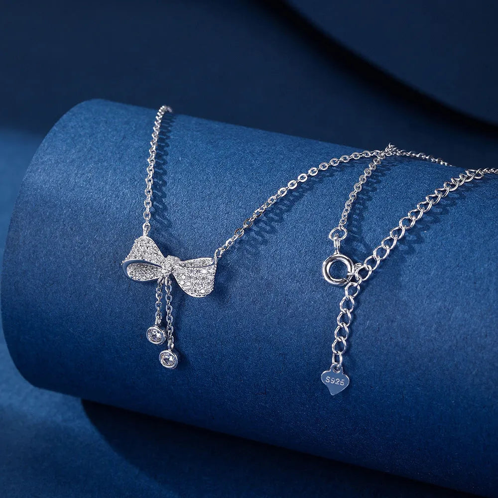 S925 sterling silver necklace with bow pendant on O-ring chain, silver colour.