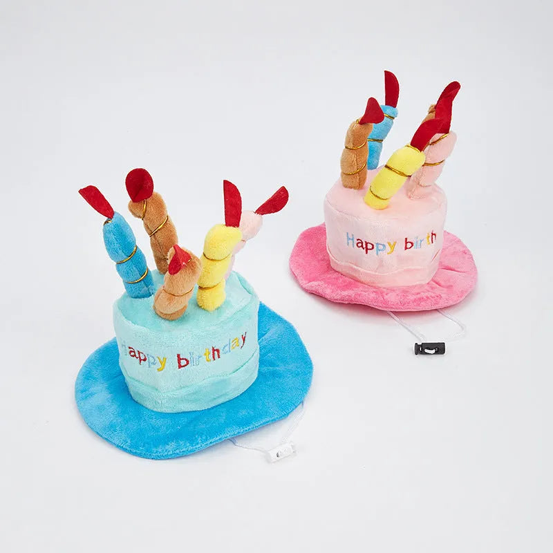 Blue and pink birthday hats for toy dogs on a festive background.