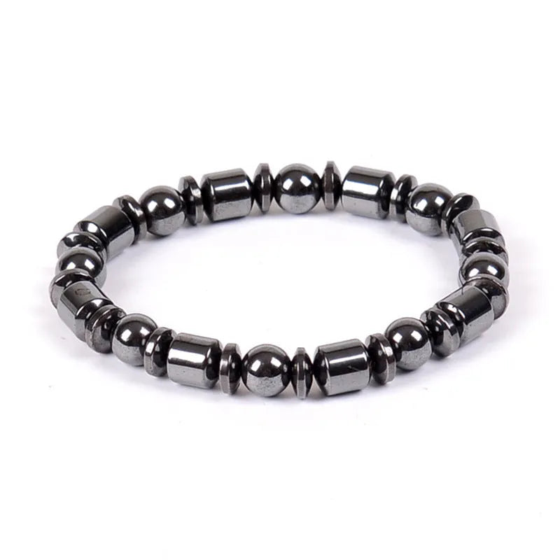 Black pentagram stone magnetic therapy bracelet with stretch fit on a wrist.