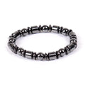 Black pentagram stone magnetic therapy bracelet with stretch fit on a wrist.