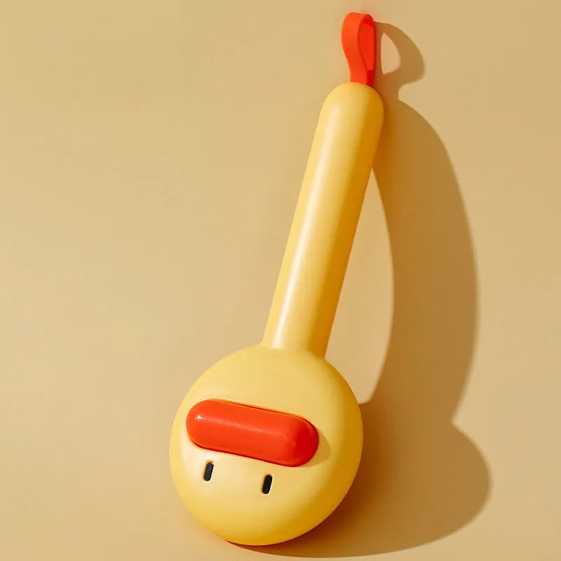 Small yellow duck-shaped pet comb with needle bristles for hair removal on cats and dogs.