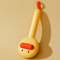 Small yellow duck-shaped pet comb with needle bristles for hair removal on cats and dogs.