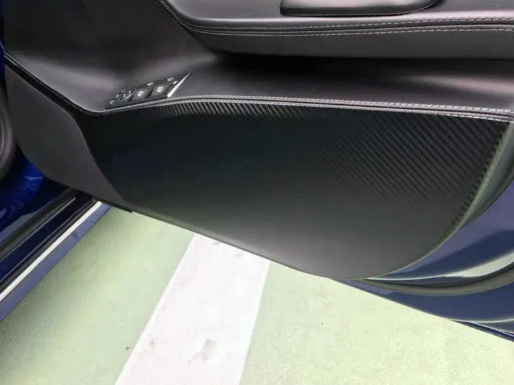 Carbon fibre protective film kit for Tesla Model S doors showing four pre-cut pieces