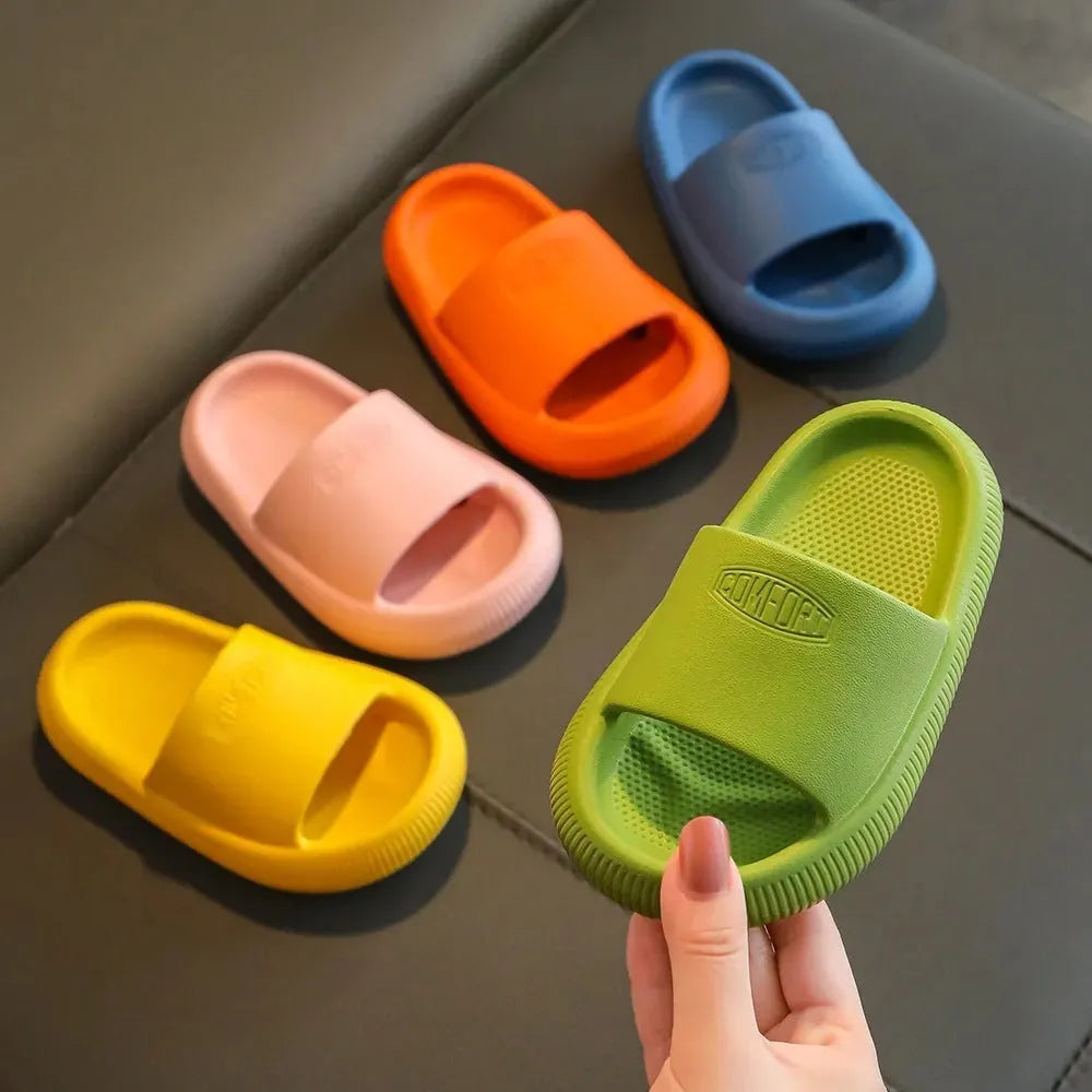 Children's colourful EVA slippers showing non-slip sole, available in blue, green, orange, pink, and yellow.