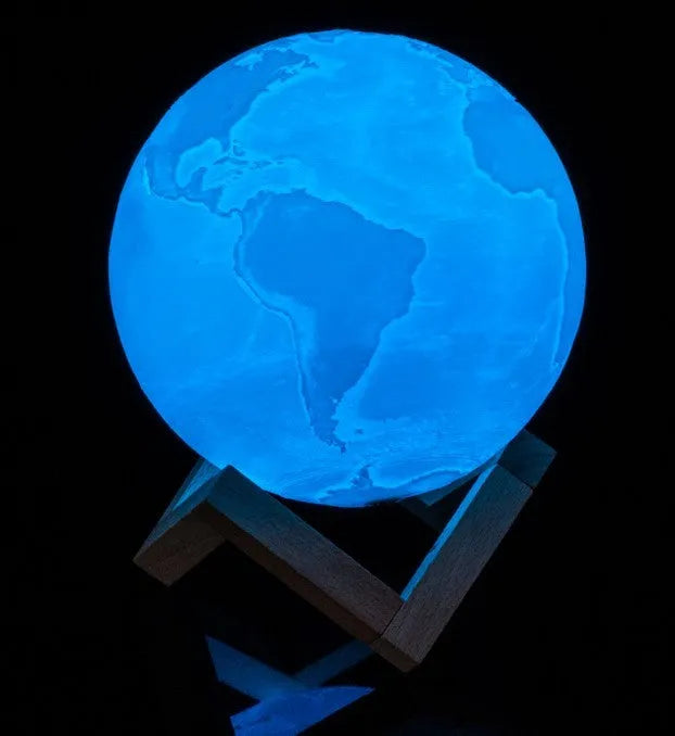 3D printed moon lamp with lunar surface detail on wooden stand, showing touch metal ring at base