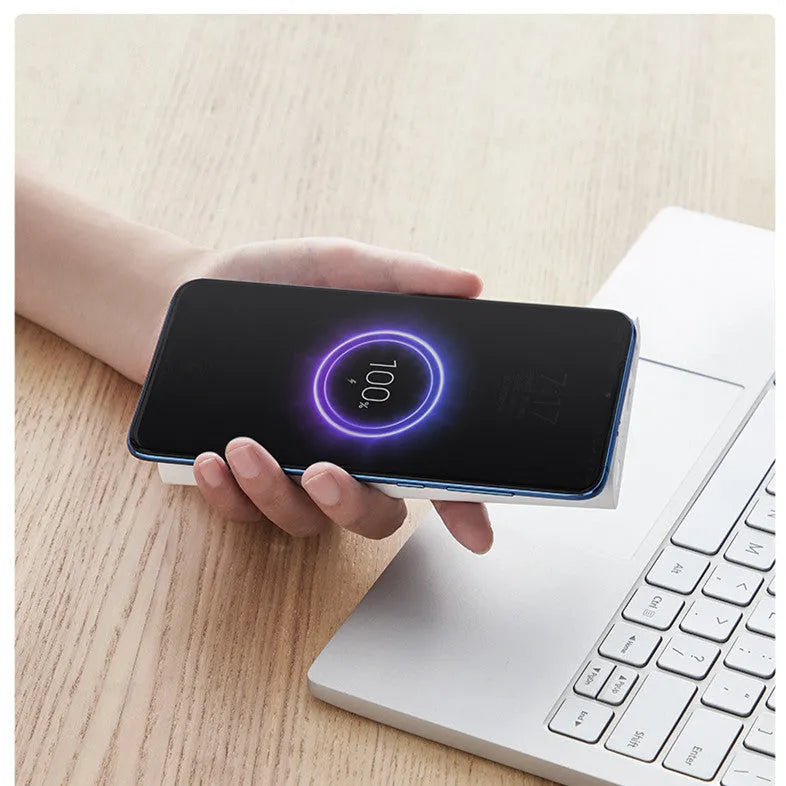 Black and white 10000 mAh power bank with USB Type-C port and wireless charging surface.