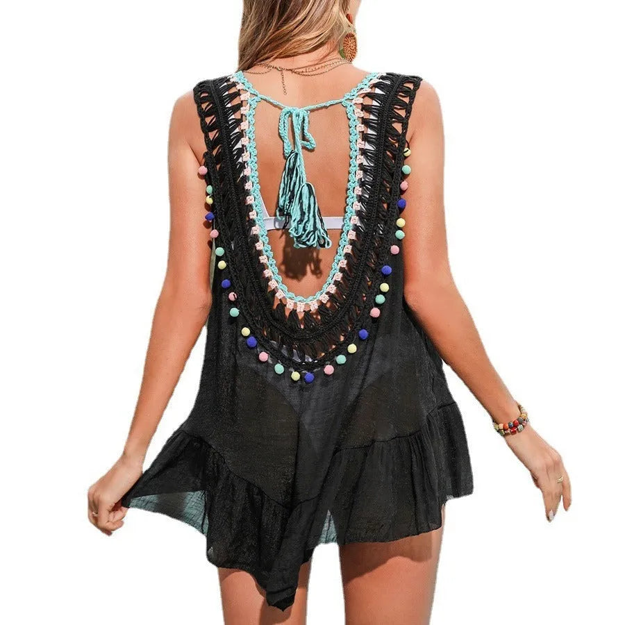 Black hand-crocheted women's beach cover-up with cut-out ruffles, shown on a model.