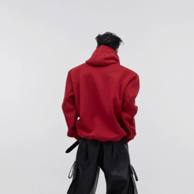 Red men's loose-fit hooded sweater with heavy shoulder pads and a metallic 3D printed design on the front.