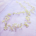 Gold and silver long hair band for weddings with crystal and pearl decoration on a wired base.