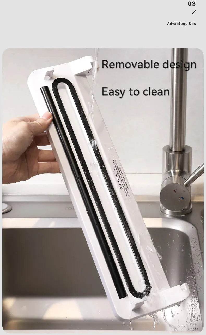 Small white automatic vacuum sealer machine for home food preservation on a kitchen counter.