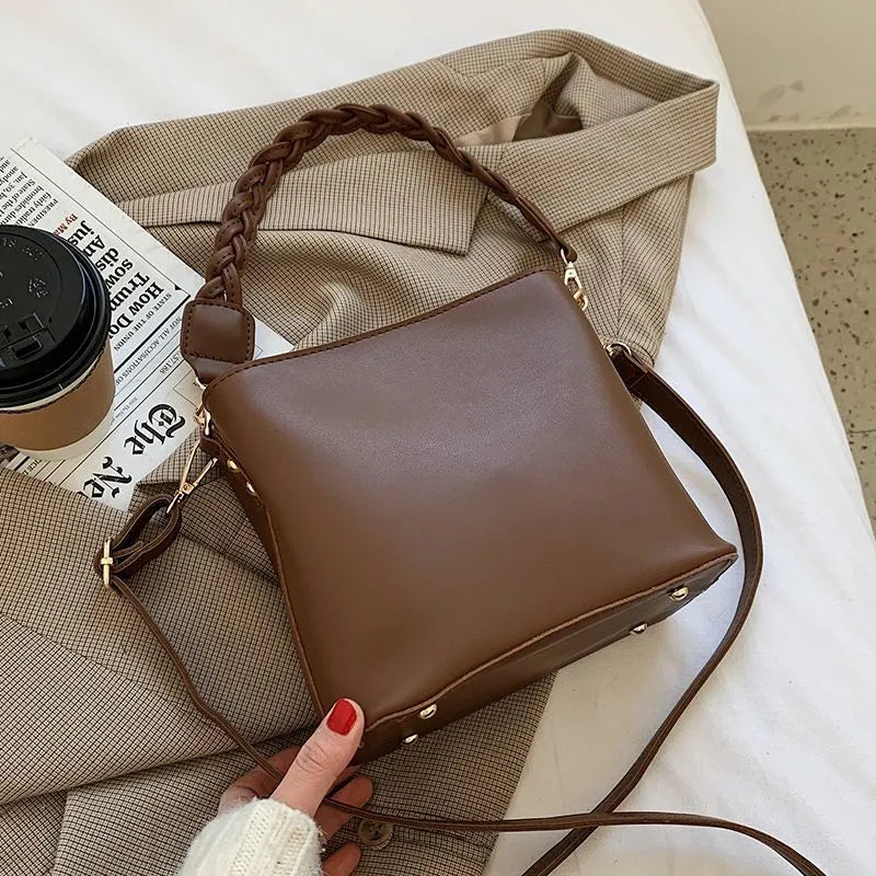 Retro-inspired woven PU crossbody bucket bag in khaki colour showing androgynous design details