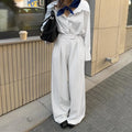 Women's white striped wide-leg trousers with side zip on mannequin