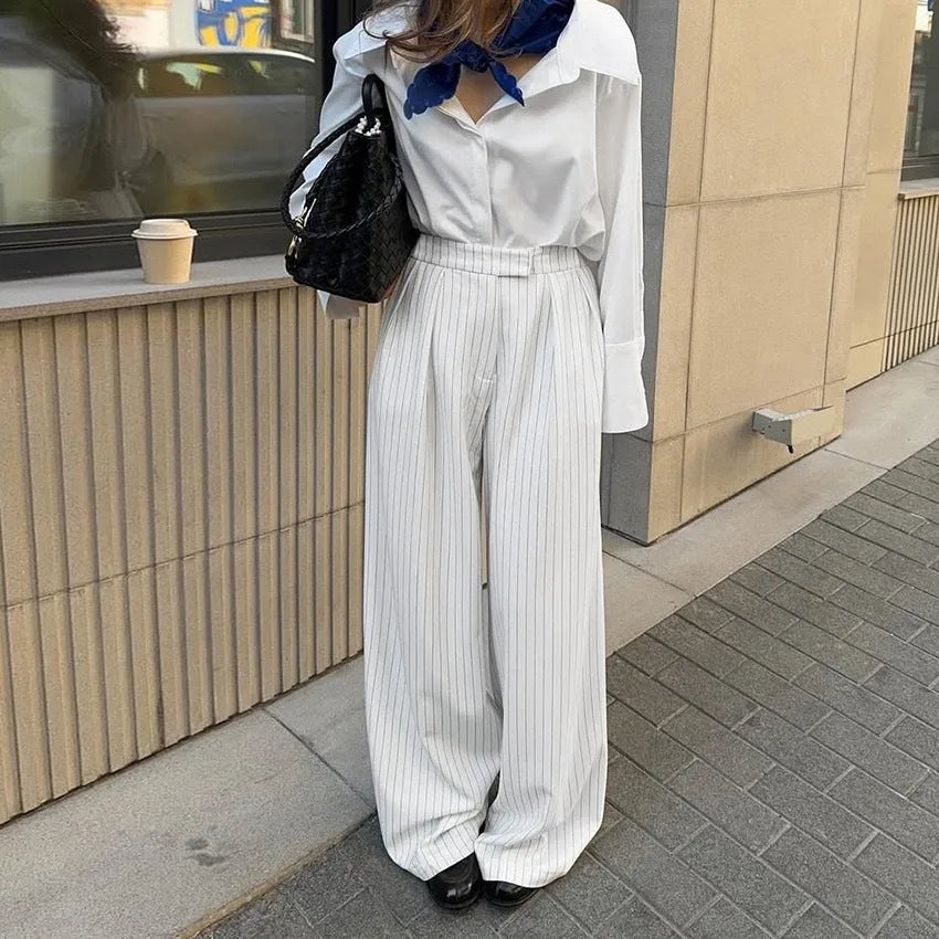 Women's white striped wide-leg trousers with side zip on mannequin