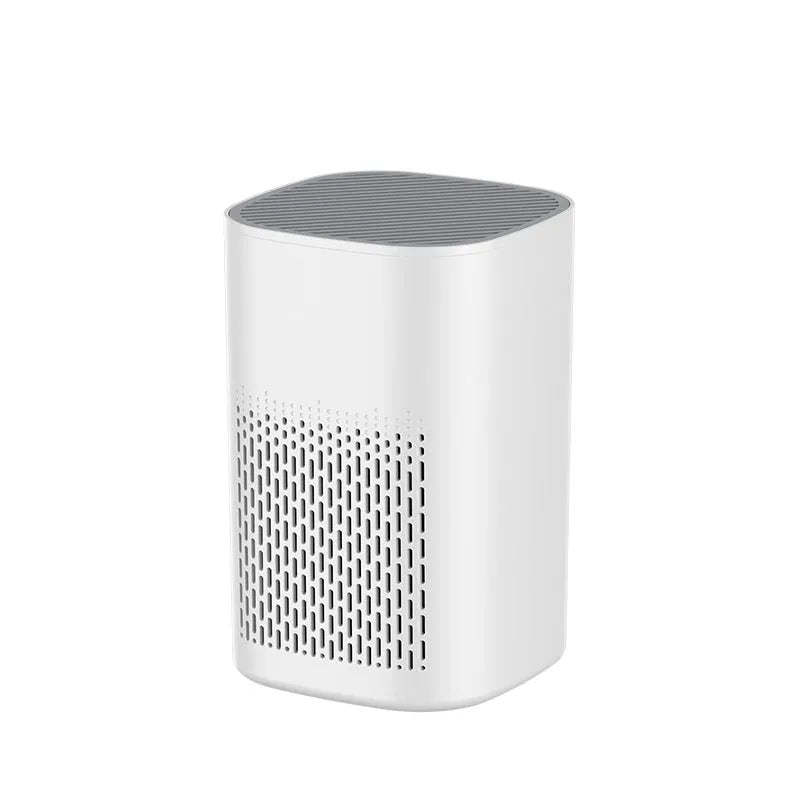 Compact white desktop air purifier with USB cable on wooden desk