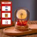 Dandelion-shaped glass night light ornament in gradient colours on a wooden surface