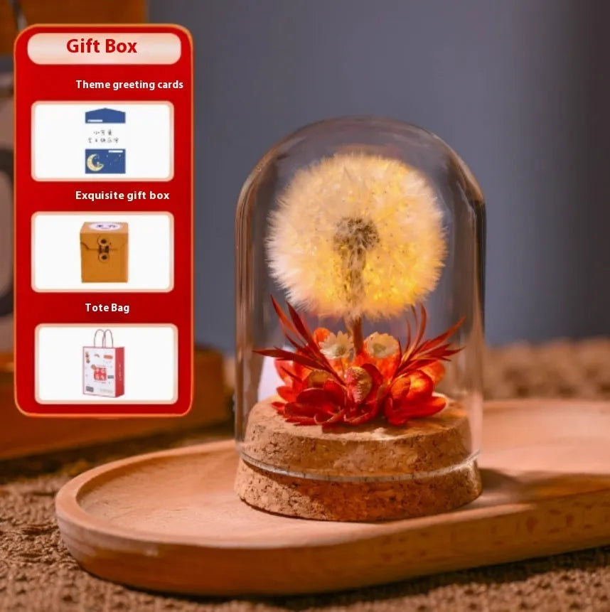 Dandelion-shaped glass night light ornament in gradient colours on a wooden surface