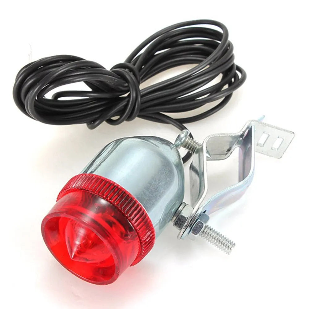 Silver bicycle dynamo generator light mounted on bicycle frame for friction-powered front and rear illumination