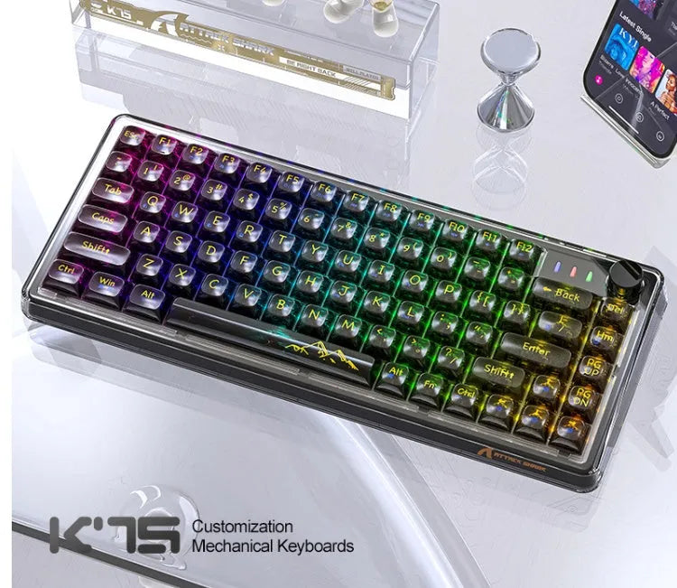 Attack Shark K75RGB transparent wireless mechanical keyboard with RGB lighting on a desk.