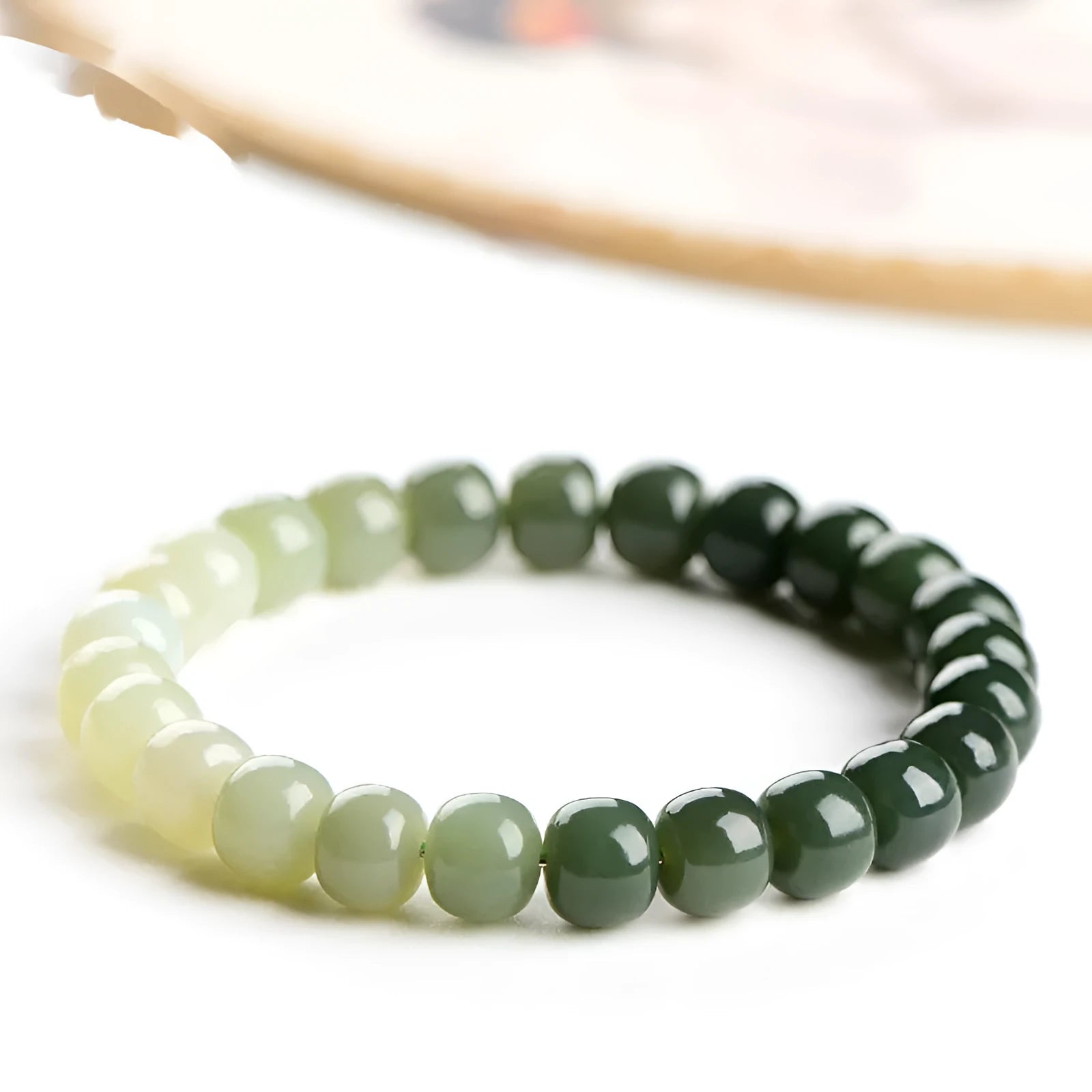 Natural Hetian jade bracelet with water gradient colours on wrist.