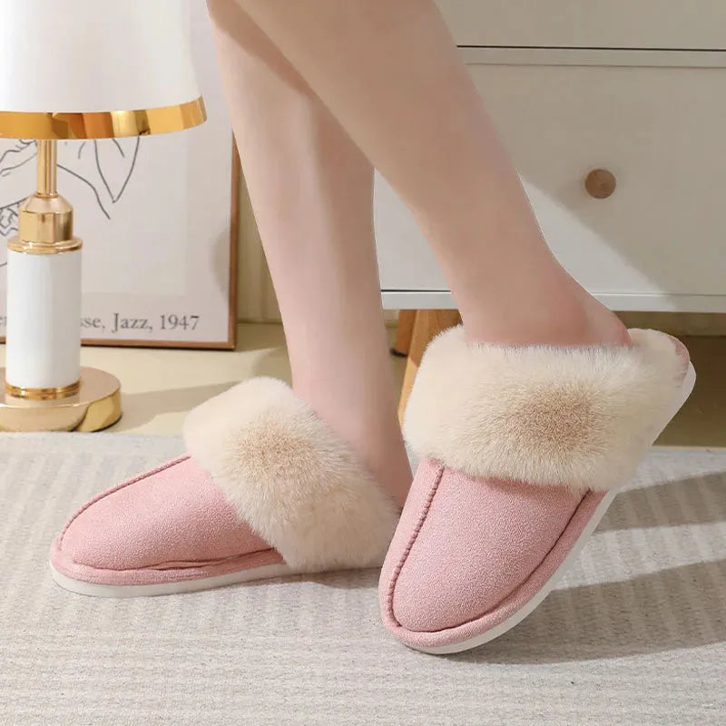 A pair of round-toe flat-heel plush slippers with stitching detail, shown in one of five available colours.