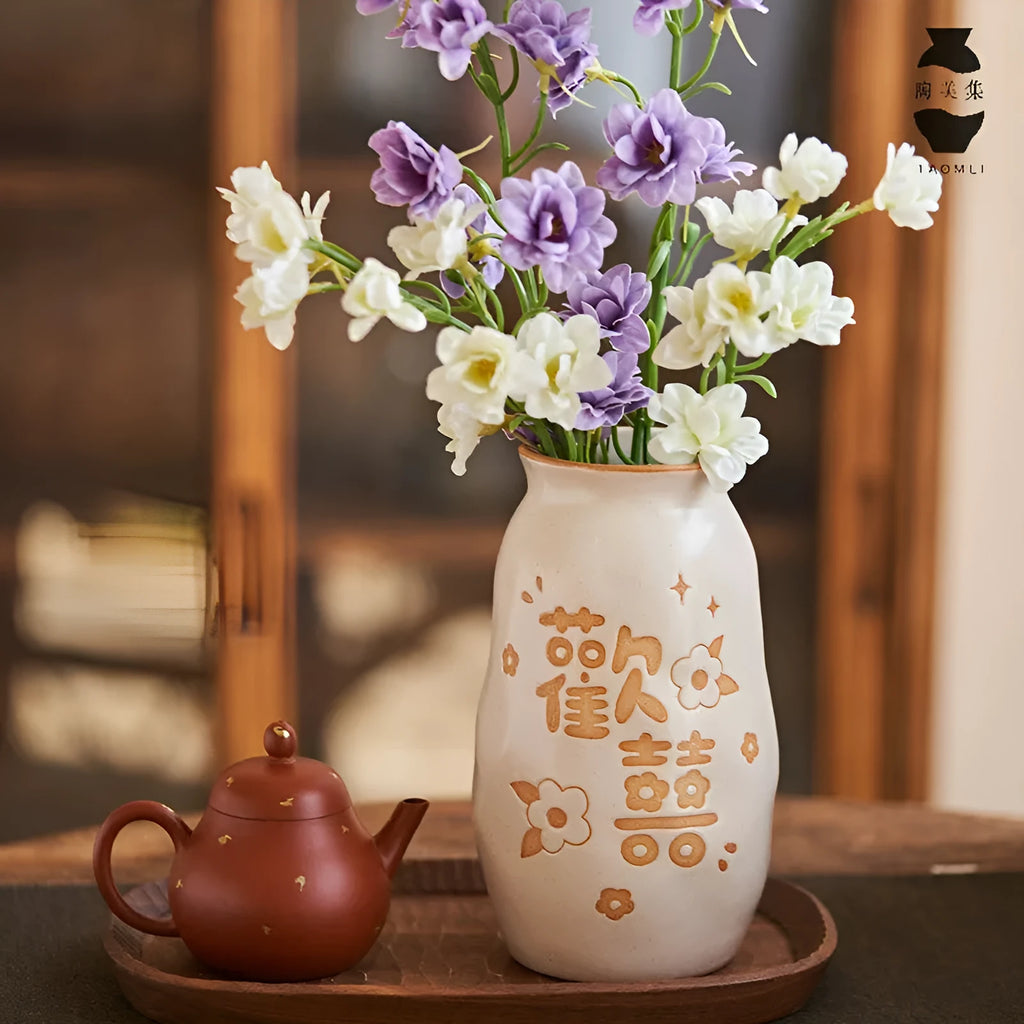 Chinese hand-painted ceramic joy vase with carved detail on desktop