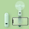 Green folding mini handheld fan with plastic blades, shown in open and closed positions.
