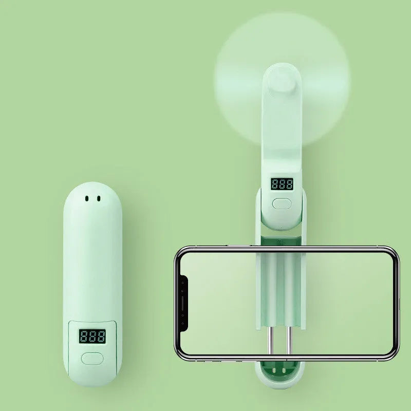 Green folding mini handheld fan with plastic blades, shown in open and closed positions.