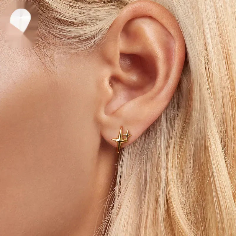 Sterling silver minimalist star ear clips with oxidised finish and clip-on fastening