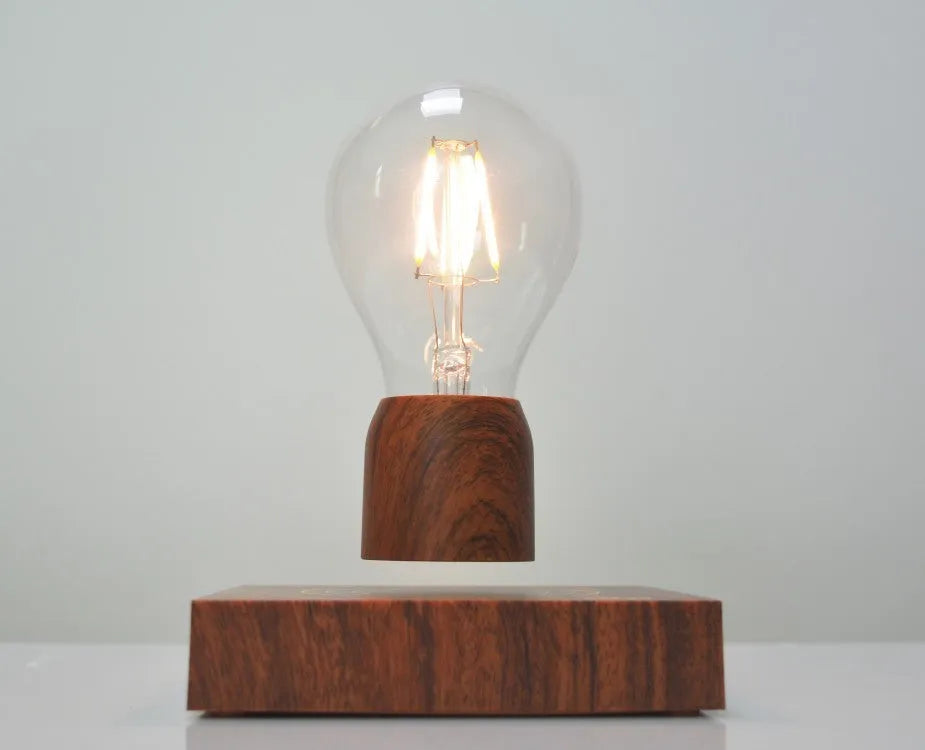 Glass and ABS magnetic levitation bulb floating above an imitation wood base.