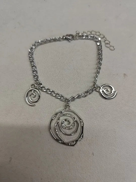 Spiral donut jewellery set with necklace, bracelet and earrings showing geometric circle designs in gold and silver finishes