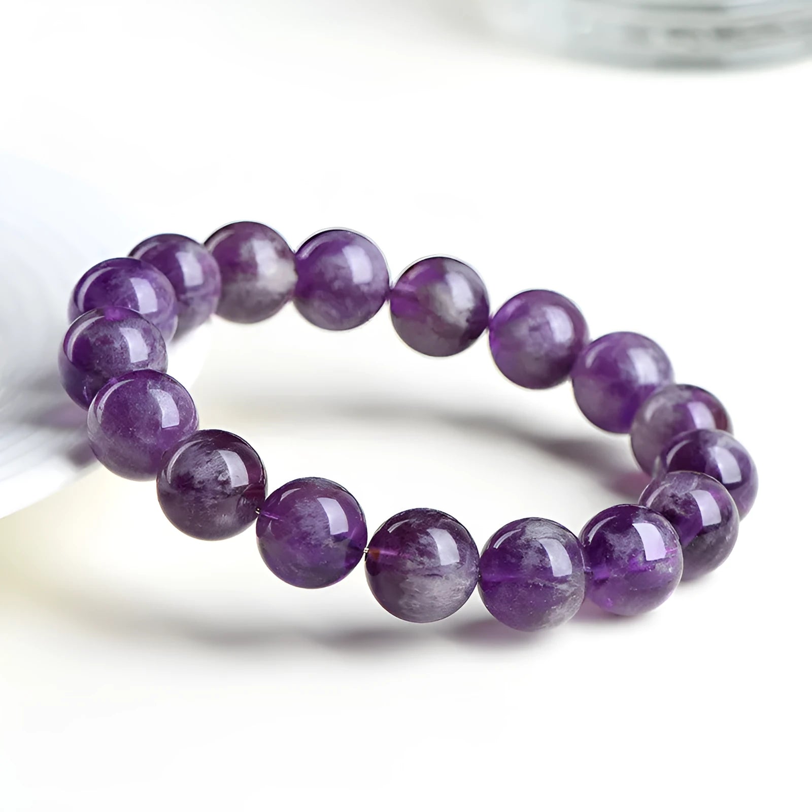 Natural purple Snow Mountain feather amethyst crystal bracelet with scattered geometry beads and Ruyi element.