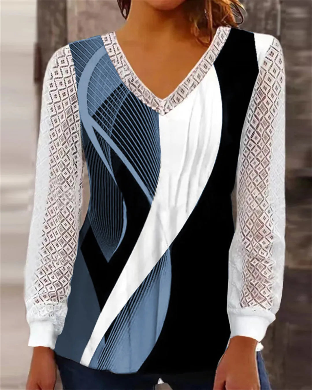 Purple loose fit V-neck lace top with long sleeves and hollow-out detail on a hanger.