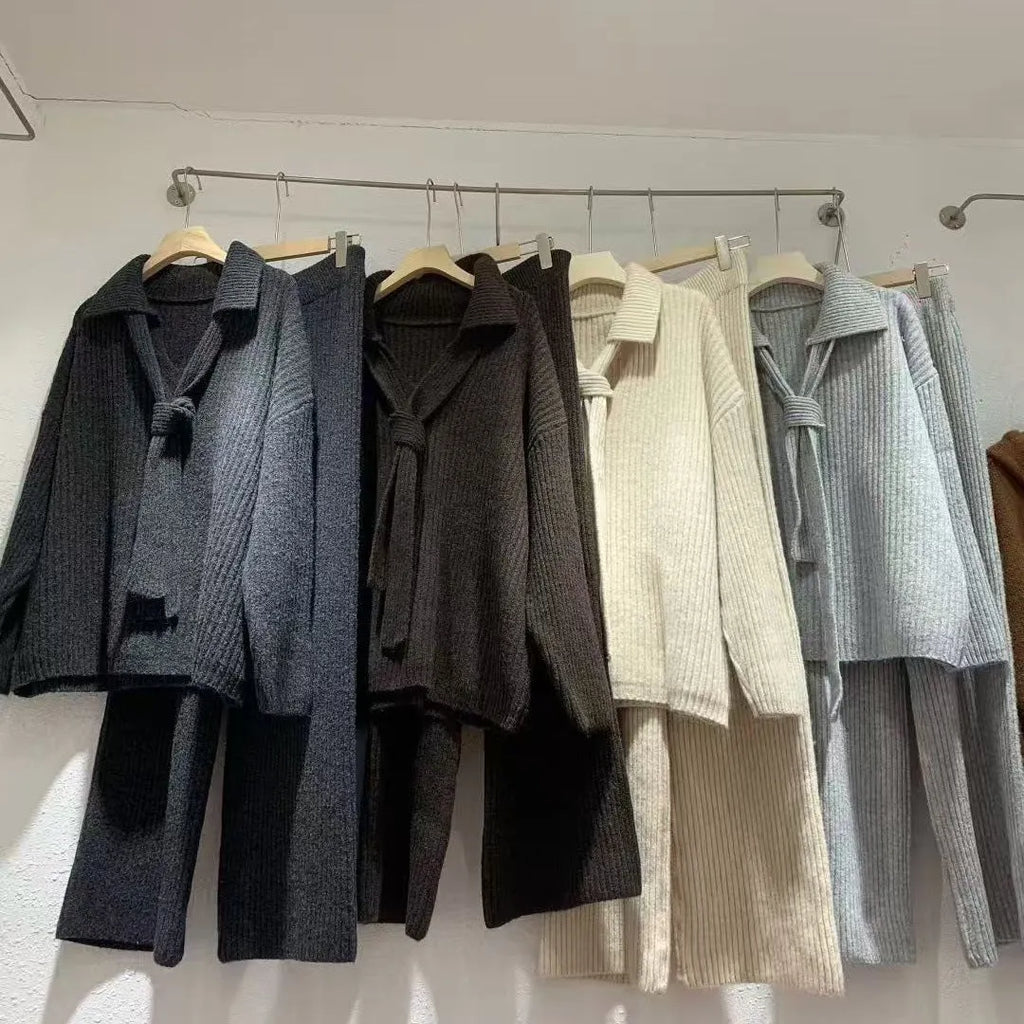 Women's dark grey knit top and trousers two-piece sweater suit set on a hanger