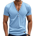 Man wearing a loose-fit grey V-neck button-front casual sports top.