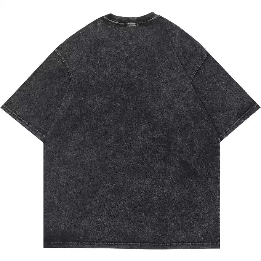 Man wearing a black cotton T-shirt with a cartoon print, showing loose fit and short sleeves.