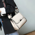 Genuine leather women's retro messenger bag in brown, showing internal organiser pockets and shoulder strap.