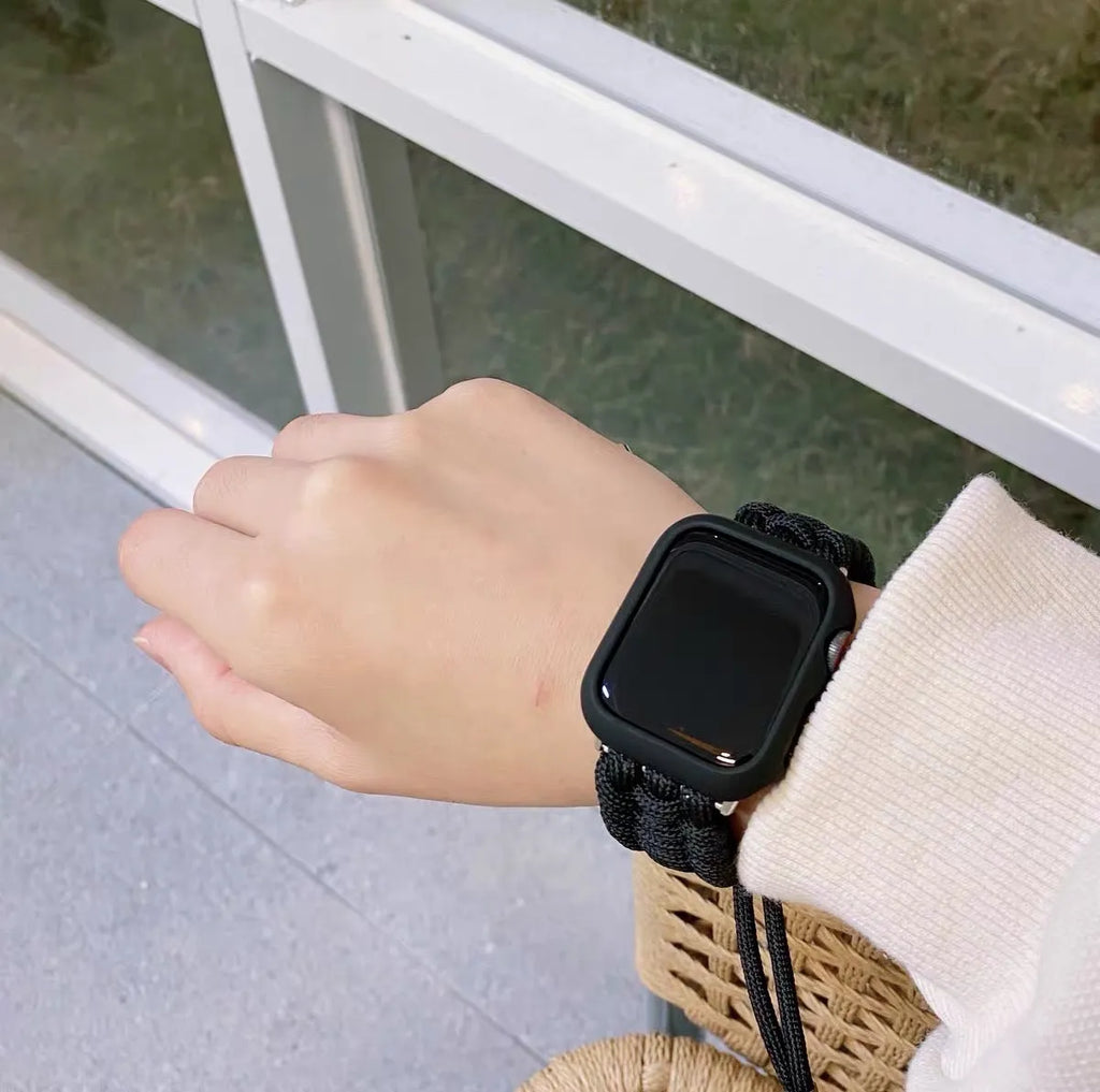 Paracord braided smartwatch strap in black showing textured nylon cord construction and standard watch lugs.